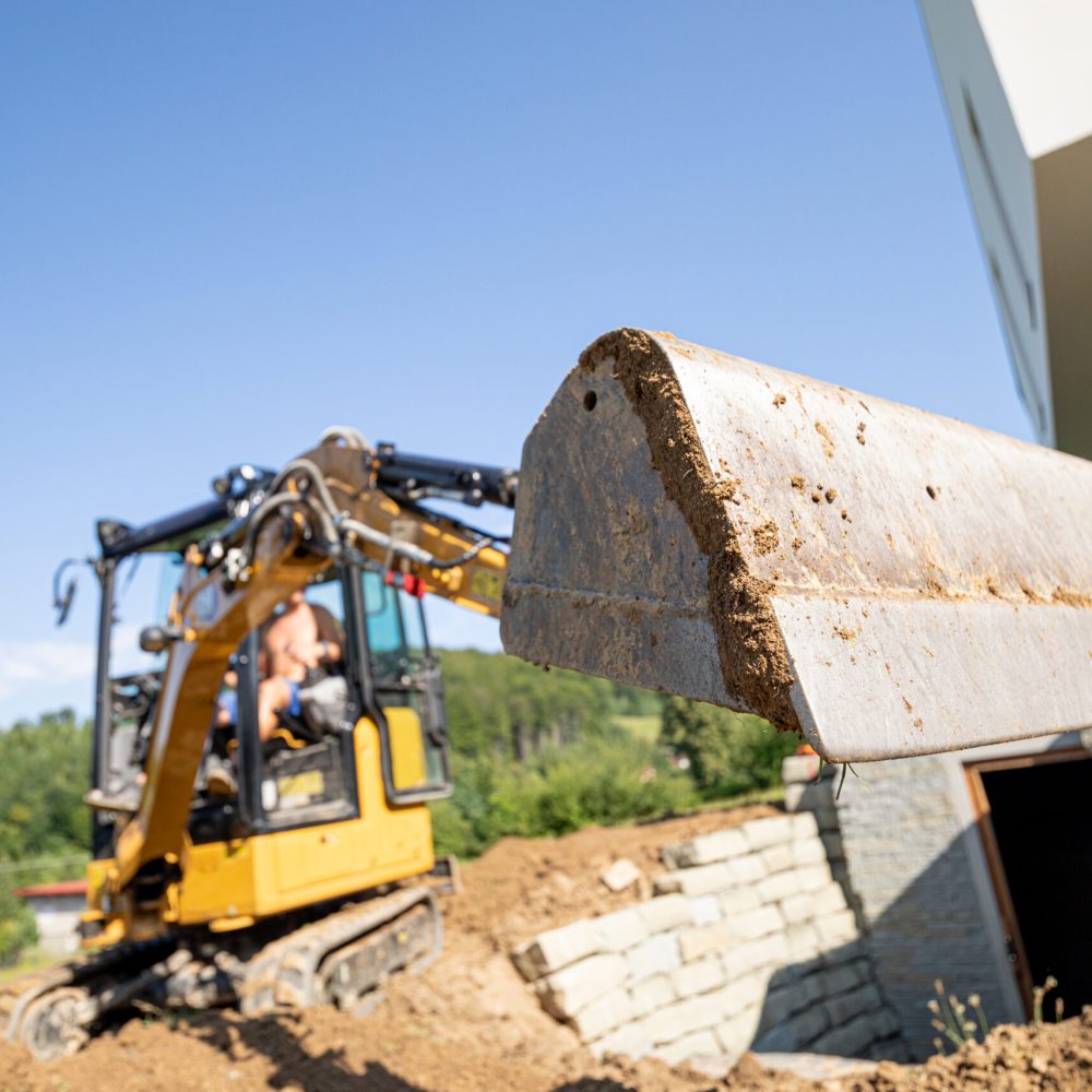 Mini Excavator bucket closeup during work on construction site